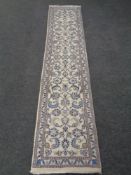 A floral carpet runner on cream ground