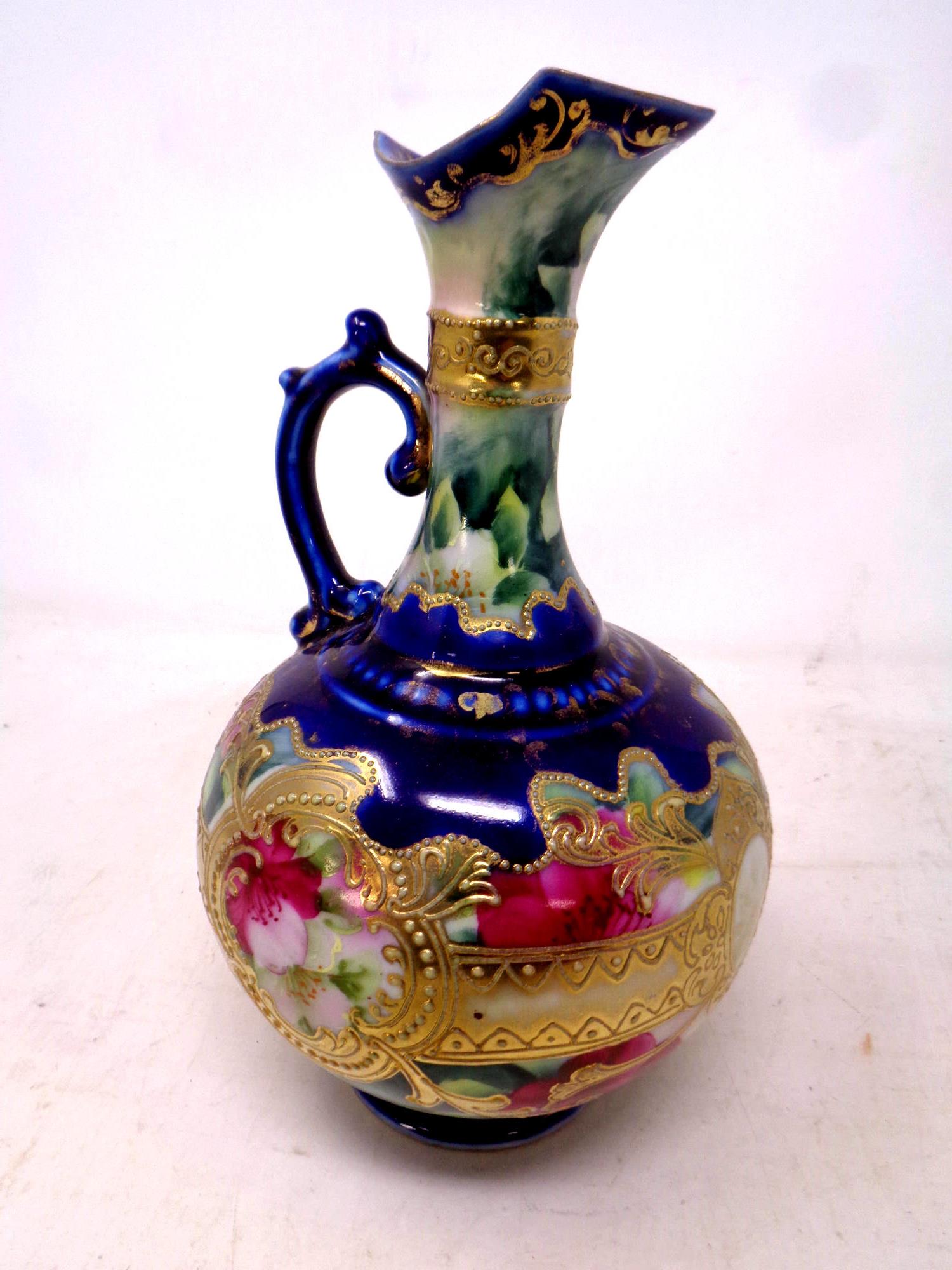 A Victorian gilt porcelain ewer, height 23 cm.