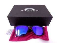 A pair of unisex Oakley Frogskins black framed sunglasses with violet iridium lenses in original