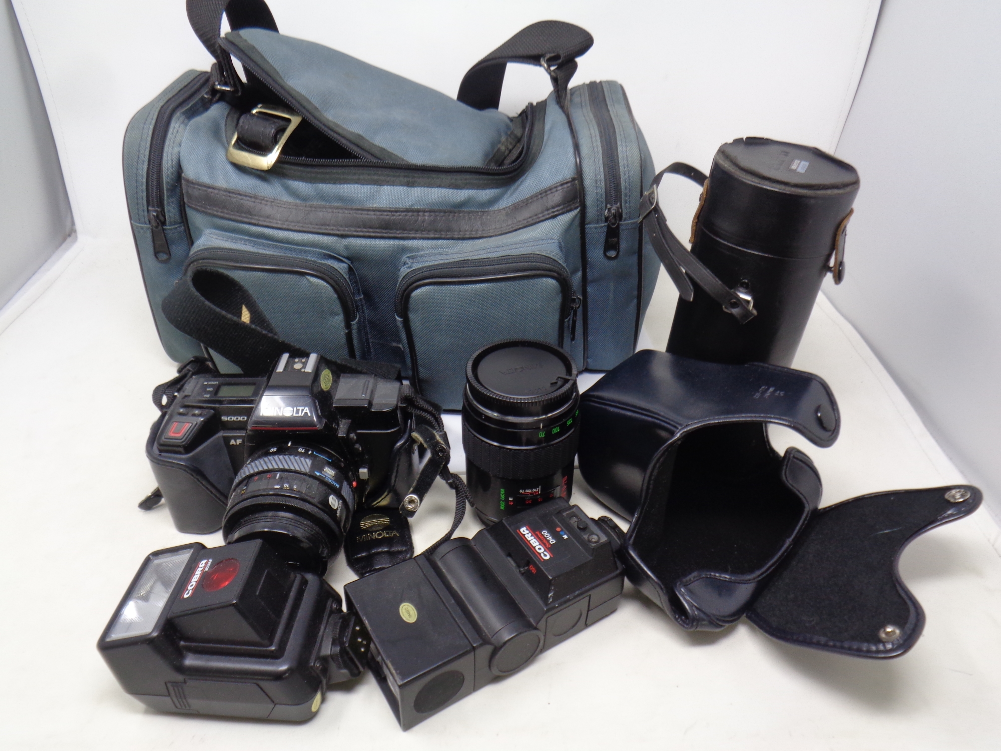 A Pentax camera bag containing a Minolta 5000 camera with lens in case together with a further case