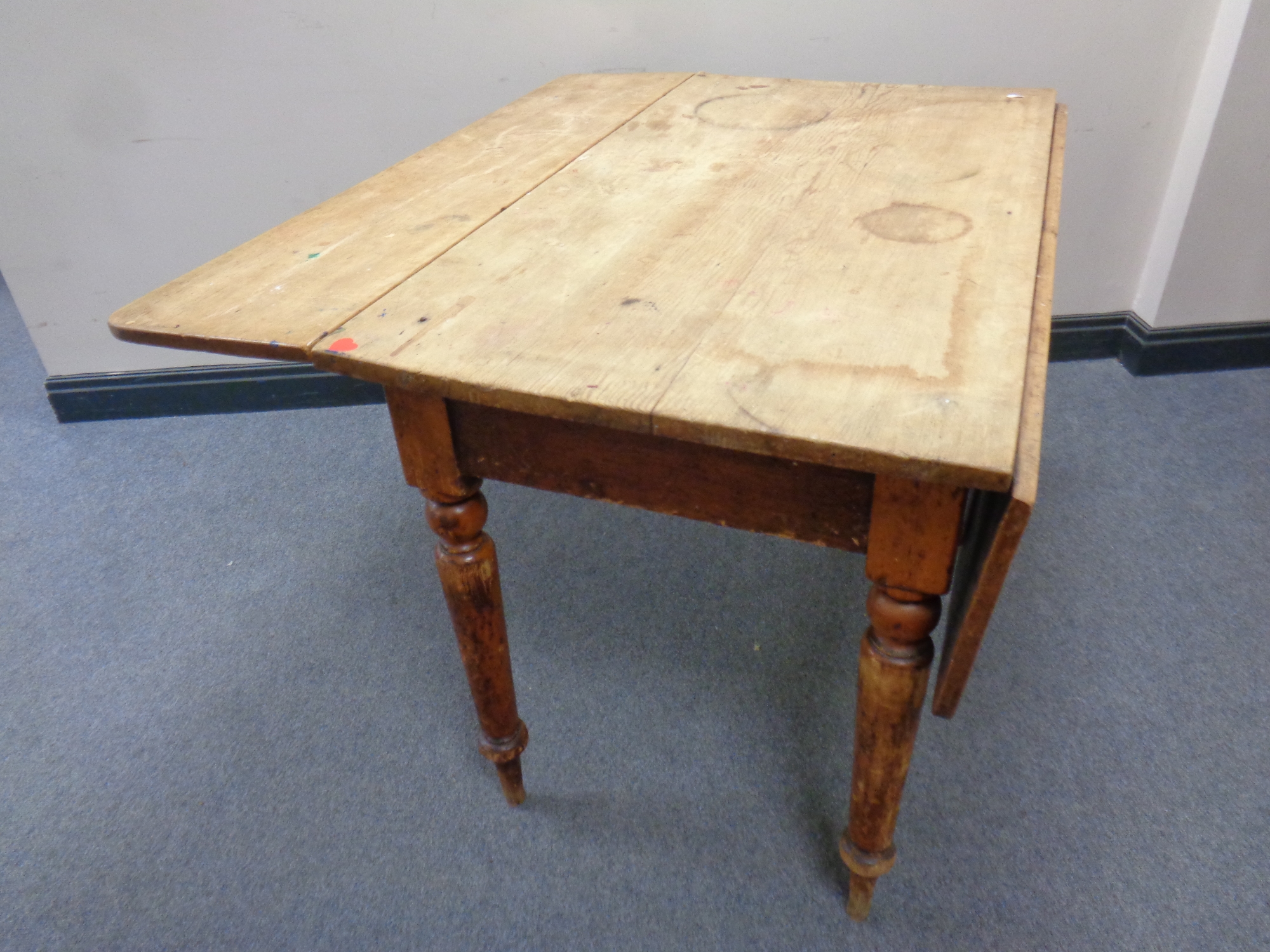 A 19th century pine drop leaf kitchen table