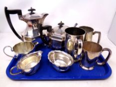 A tray containing five pieces of silver plated tea ware together with three further plated tankards.