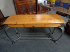 A contemporary pine hall table fitted with draw on metal legs