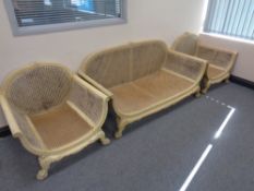 An antique French wood framed bergere three piece suite (lacking cushions)