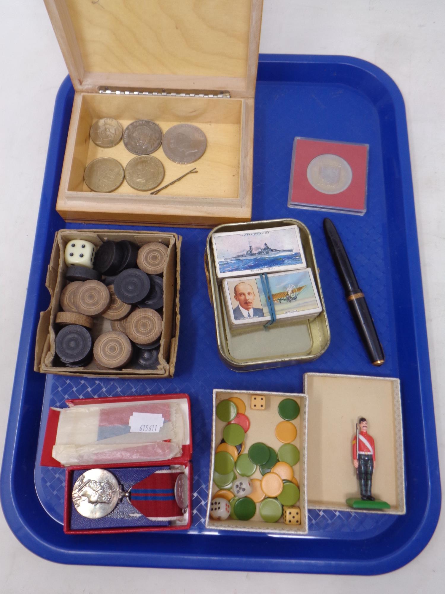 A tray containing a Queen Elizabeth coronation medal, a Parker fountain pen with gold nib,