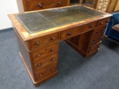 A Victorian mahogany twin pedestal desk fitted with nine drawers with a tooled leather inset panel
