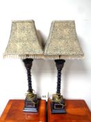 A pair of contemporary table lamps with tasseled shades