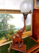 A carved hardwood table lamp modelled as an elephant