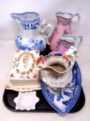 A tray containing antique ceramics to include two graduated Josiah Wedgwood jugs,