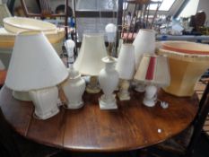 A quantity of assorted ceramic and marble table lamps together with a quantity of assorted shades.