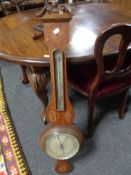 A 19th century inlaid oak aneroid barometer by F Robson and Co of Newcastle.