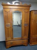 An Edwardian satin wood mirrored door wardrobe fitted drawer beneath