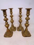 A set of four Victorian brass candlesticks