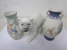 A Lladro figure of a Polar bear together with two Lladro embossed vases.