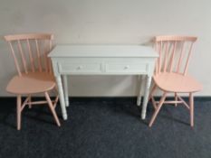 A pair of painted spindle back kitchen chairs together with a contemporary two drawer side table