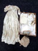 A box containing a vintage satin and lace wedding dress together with hand embroidered Alone from