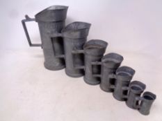 A set of seven graduated French pewter measuring jugs