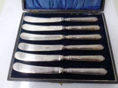 A set of six silver handled butter knives in case.