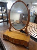 A 19th century oval dressing table mirror on stand fitted drawers