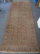 An antique Bokhara runner, Afghanistan, on brown ground,