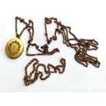 An antique yellow metal muff chain, together with two further chains and a pendant.