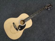 A Martin Smith W-100-N-PK acoustic guitar.