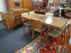 A 8 piece walnut Art Deco dining room suite comprising of inverted breakfront cocktail sideboard,