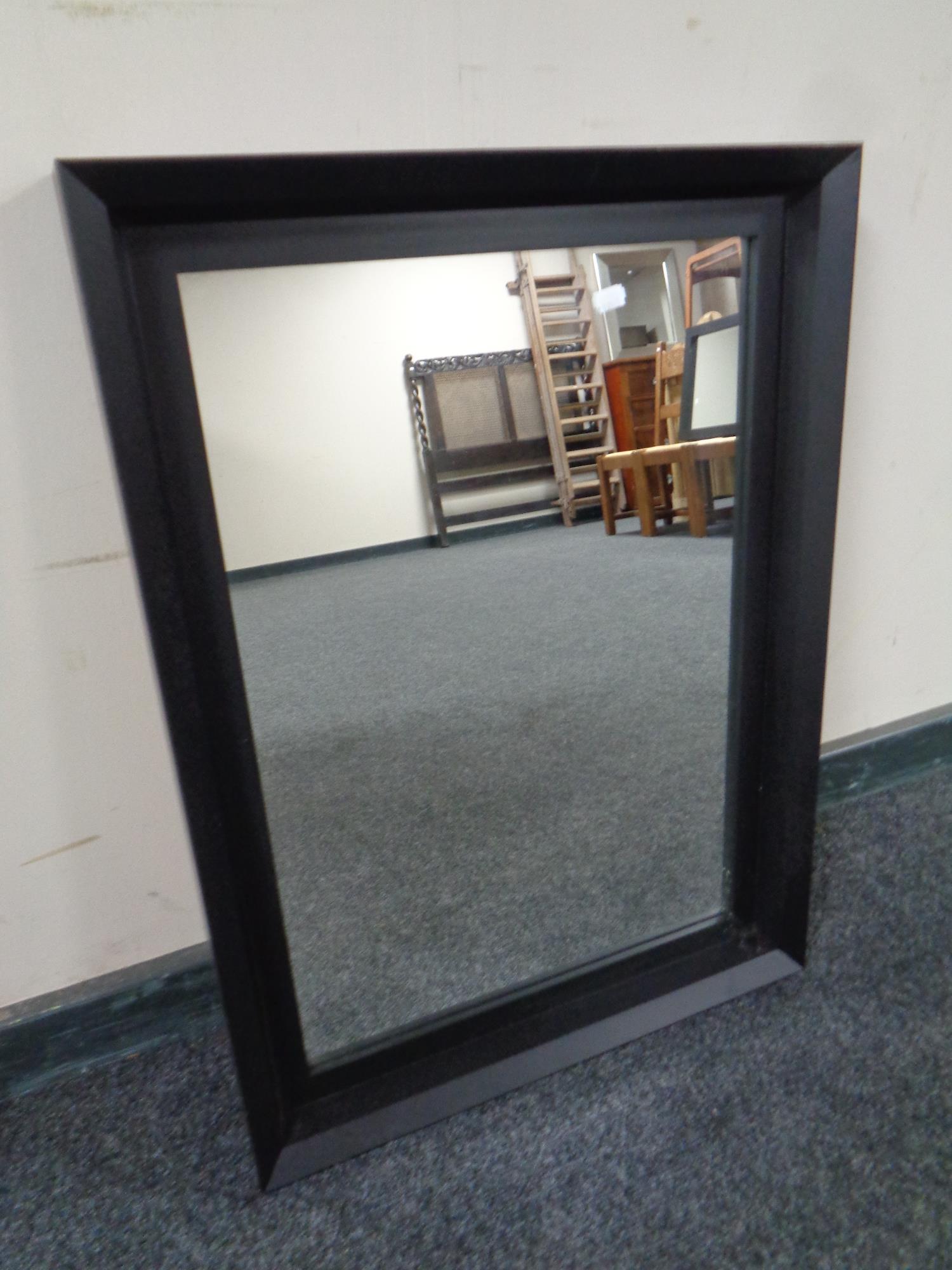 A contemporary black framed mirror