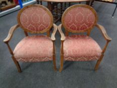 A pair of Edwardian beech salon armchairs upholstered in a pink brocade fabric