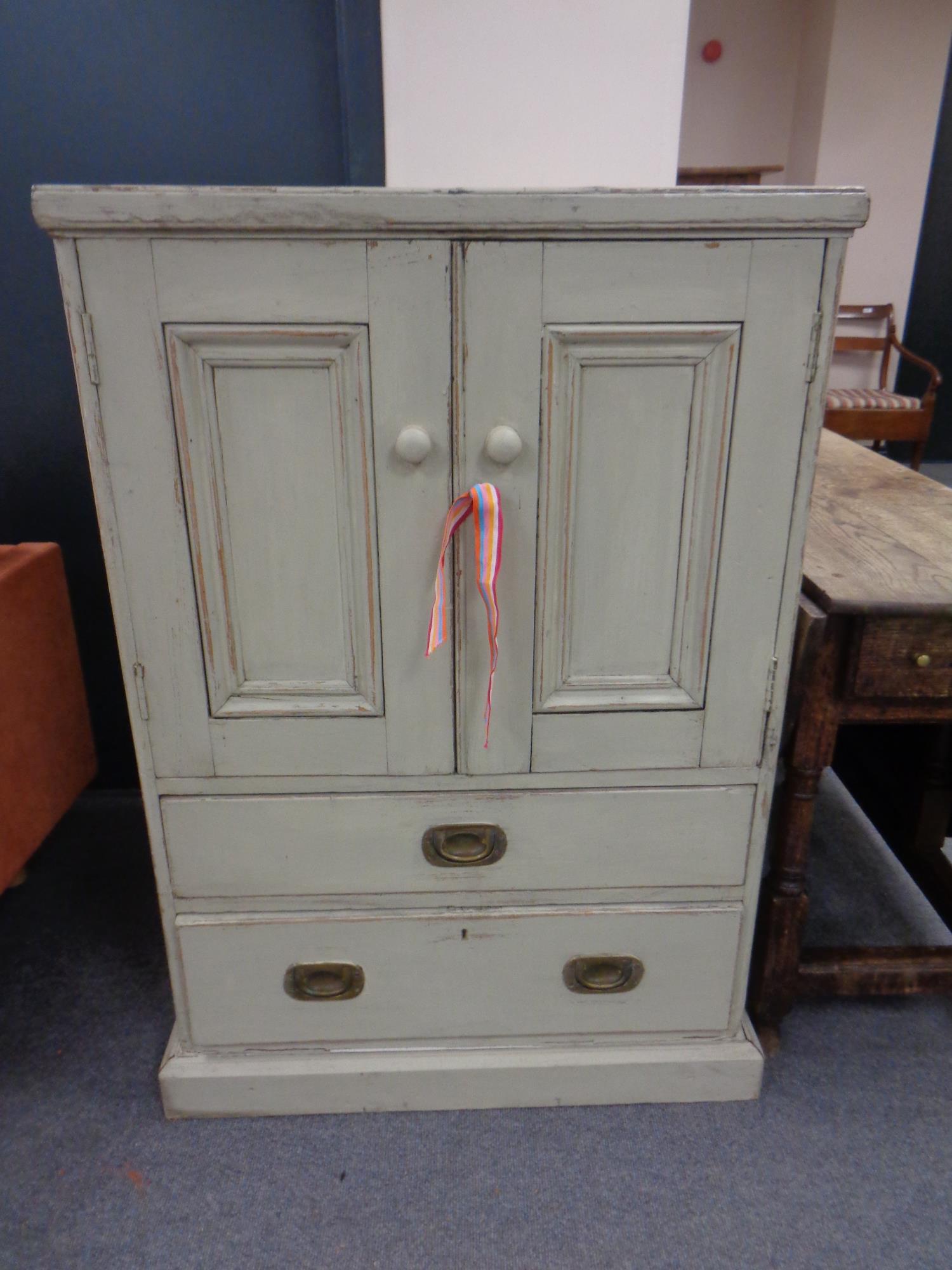 A contemporary pine painted double door audio cabinet fitted two drawers beneath