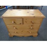 A stripped pine four drawer chest