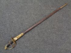 A 19th century brass hilted court sword in leather and brass mounted scabbard