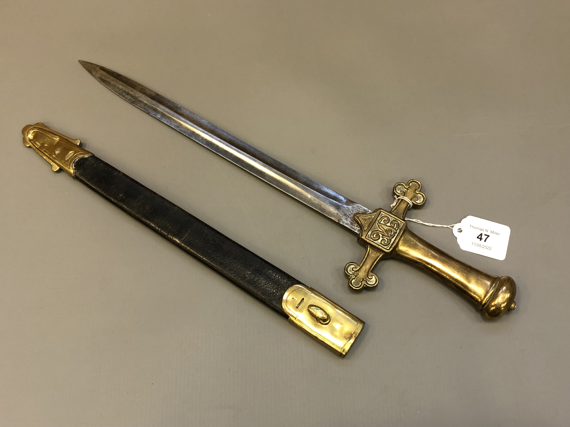 A Victorian brass-hilted bandman's sword in leather sheath