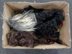 A box containing ten wigs.