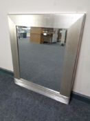 A contemporary silver framed bevel edged mirror