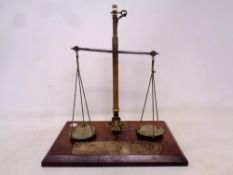 A set of Victorian brass micro scales mounted on mahogany board