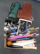 Two bags containing assorted golfing irons and drivers together with a further box containing