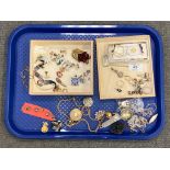 A tray of costume jewellery, brooches, chain, pendant etc.