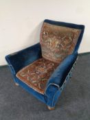 A Victorian armchair upholstered in blue dralon and Caucasian Afshar carpet