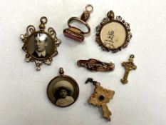 A collection of antique pendants, fob, yellow metal crucifix, antique bar brooch,