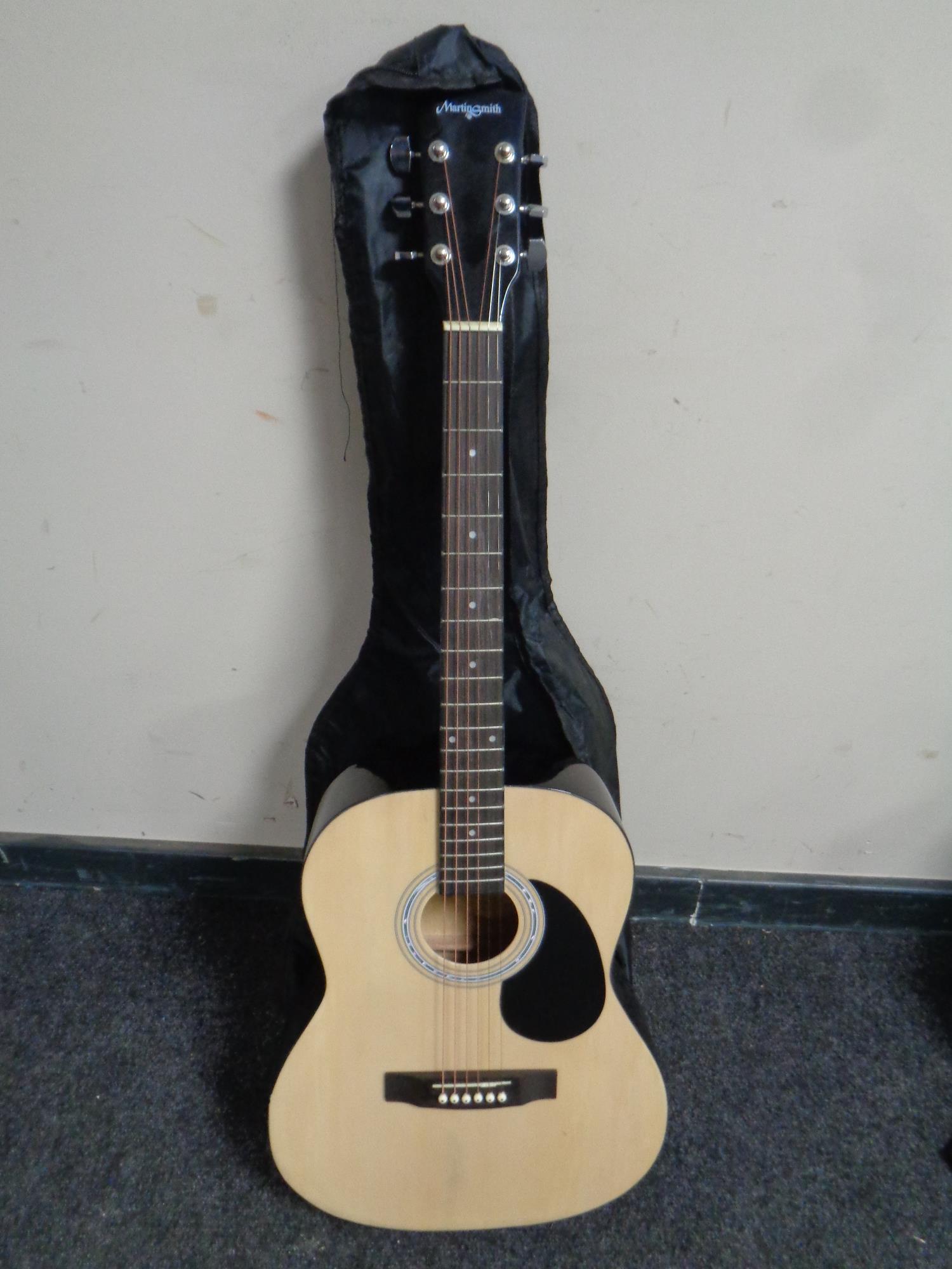 A Martin Smith W-101-N-PK (natural) acoustic guitar in carry bag.