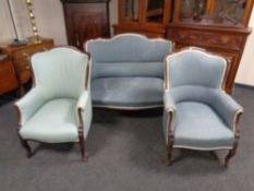 An Edwardian mahogany framed three piece lounge suite