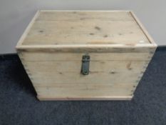 An antique stripped pine storage crate