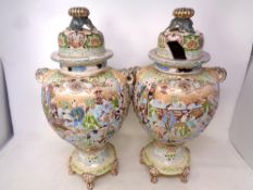 A pair of Chinese embossed crackle glazed lidded vases on raised feet, height 42.5 cm.