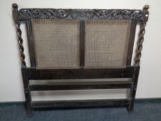 An Edwardian carved oak and barley twist bergere headboard