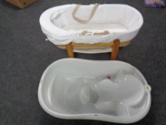 A Mamas and Papas baby bath together with a Moses basket on stand