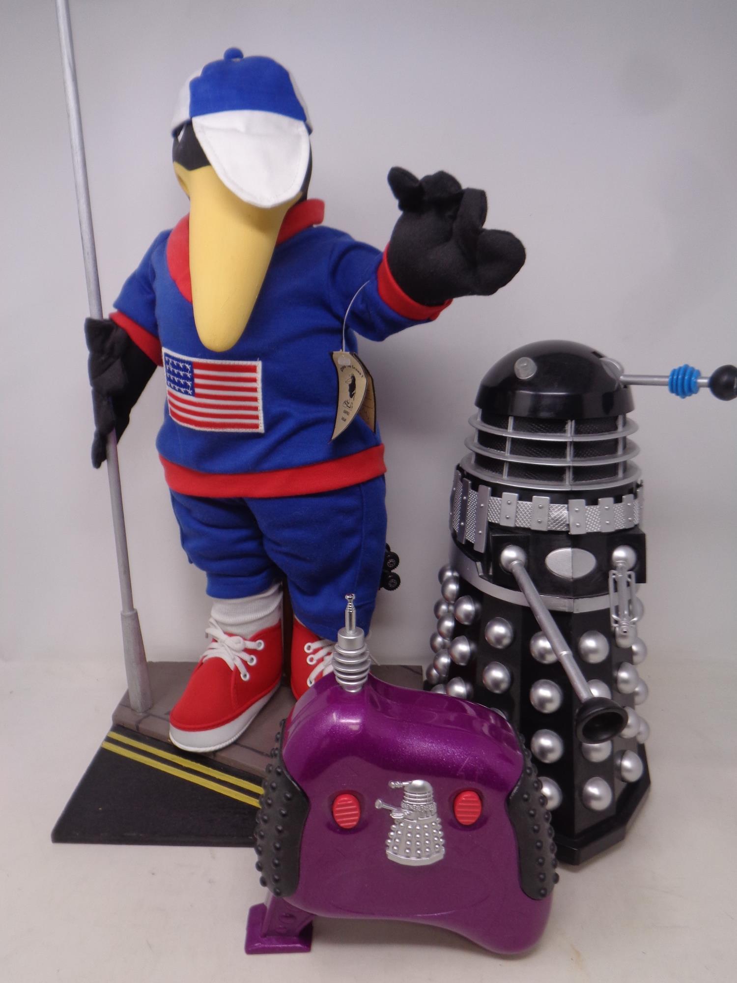 A remote controlled Dalek together with a Stone the Crows soft toy ice skating figure with original