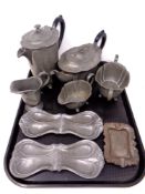 A tray of antique pewter, four piece Minster tea service, shallow trays,