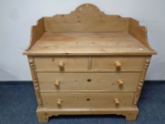 A stripped pine four drawer wash stand