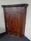 A George III inlaid mahogany hanging panel door corner cabinet fitted three drawers beneath